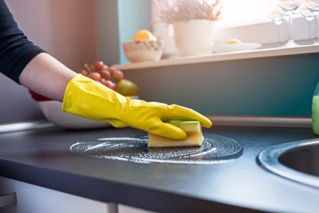 professional cleaner cleaning kitchen surfaces during summer in New Jersey