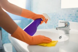 Professional cleaner removing buildup from a bathroom in a New Jersey home