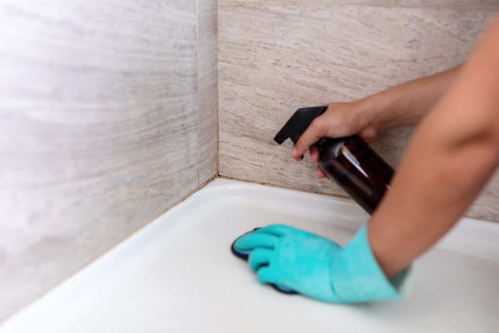 Professional cleaner deep cleaning shower grout in a New Jersey bathroom