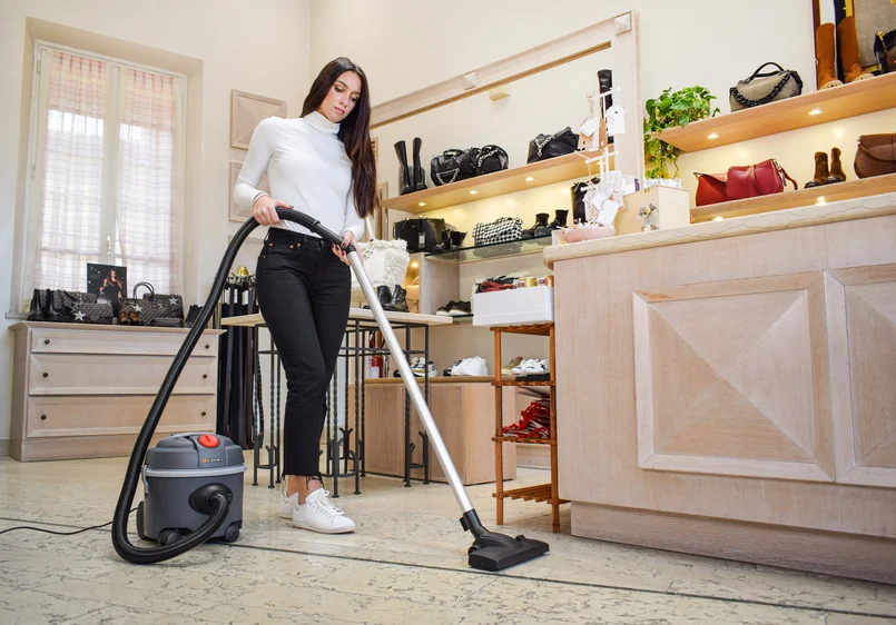 Professional cleaner deep cleaning a living room in a New Jersey home