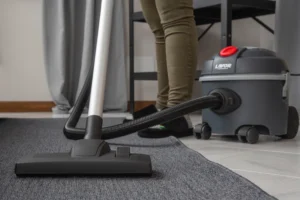 Professional cleaner removing hidden dirt and dust after summer in a New Jersey home